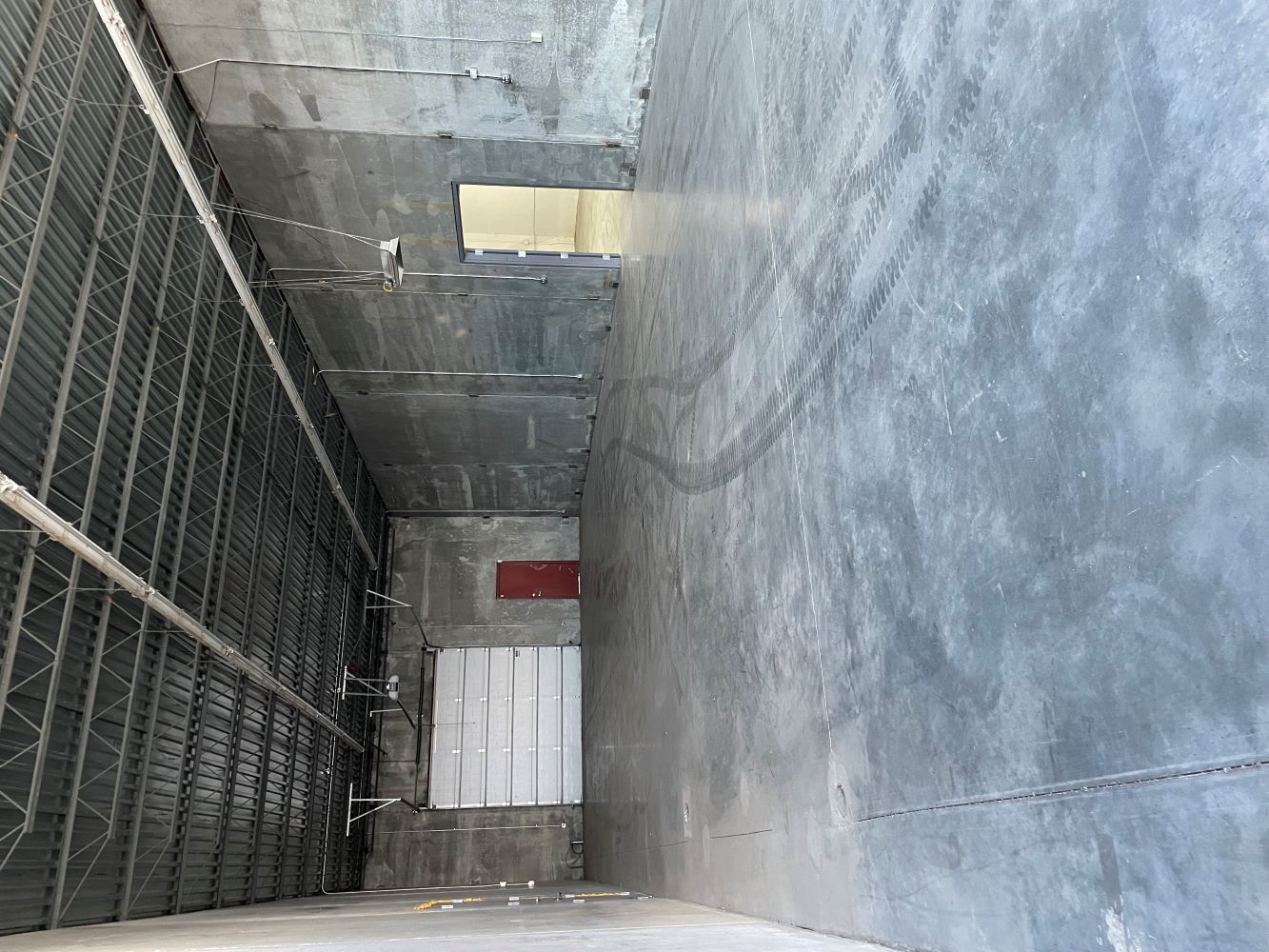 Interior of a Northview Business Plaza bay showing reinforced concrete floor and garage door